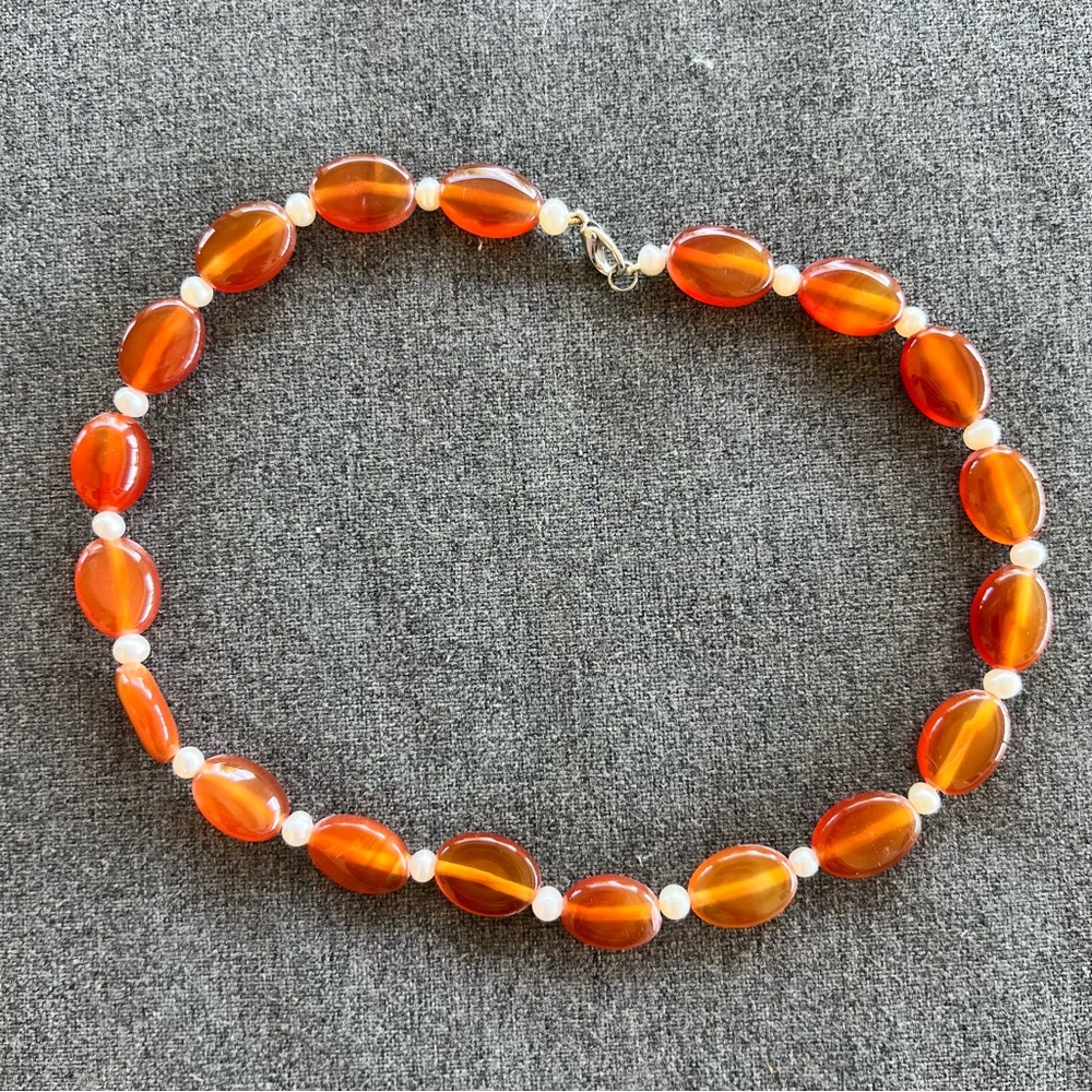 Genuine orange carnelian or agate oval beads and small white accent beads 16”